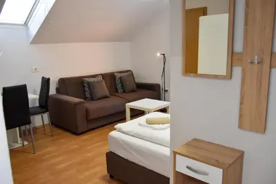 a living room with a couch and a table at Apartments Park Vodice - Ljubljana, Krvavec in Woditz