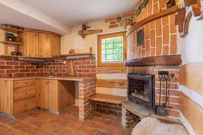 a kitchen with a brick fireplace in a room at Holiday home in Novo Mesto - Dolenjska Bela krajina Unter- Weißkrain 35158 in Novo Mesto