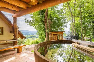 a porch with a bench and a view of the mountains at Holiday home in Novo Mesto - Dolenjska Bela krajina Unter- Weißkrain 35158 in Novo Mesto