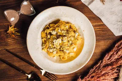 a bowl of food on a wooden table at LAGOJA b&b in Trzin