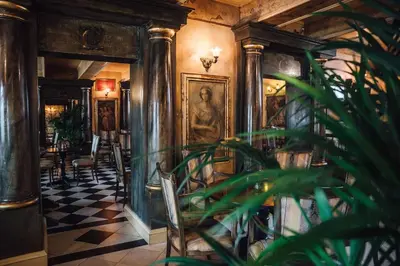 a room with a checkered floor and pillars at LAGOJA b&b in Trzin