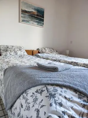 two beds sitting next to each other in a bedroom at Family Hostel Pivka in Pivka