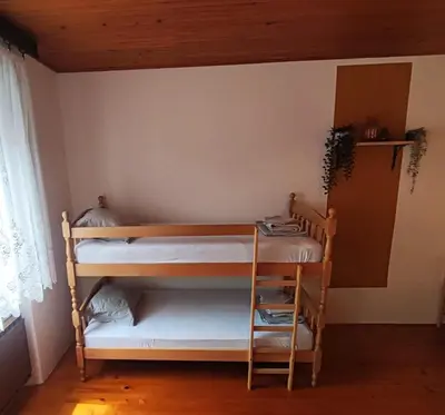 a bedroom with two bunk beds in a room at Family Hostel Pivka in Pivka