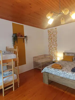 a room with a bed and a table in it at Family Hostel Pivka in Pivka