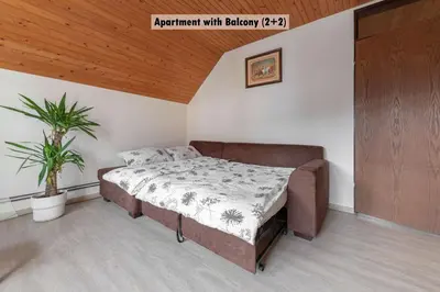 a bedroom with a bed and a potted plant at Apartments Farm House Uric in Jesenice