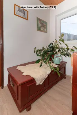 a table with a potted plant on top of it at Apartments Farm House Uric in Jesenice