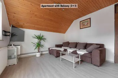 a living room with a couch and a table at Apartments Farm House Uric in Jesenice