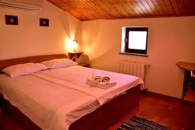 a bedroom with a bed with a pair of scissors on it at Tourist Farm Škerlj in Dutovlje