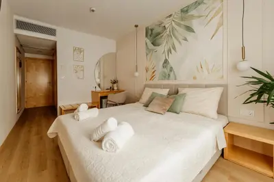 a bedroom with a white bed with towels on it at Hotel Jeruzalem in Ljutomer