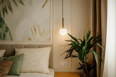 a bedroom with a bed and a potted plant at Hotel Jeruzalem in Ljutomer
