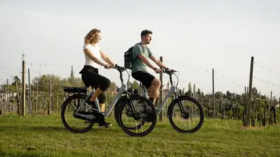 a man and woman riding bikes in a field at Hotel Jeruzalem in Ljutomer