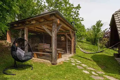 a swing in the grass in front of a gazebo at Holiday home in Novo mesto - dostava - Kranjska Krain 26036 in Trška Gora