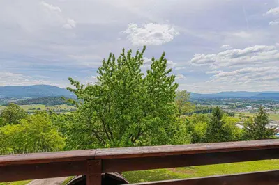 a view of a valley from a wooden railing at Holiday home in Novo mesto - dostava - Kranjska Krain 26036 in Trška Gora