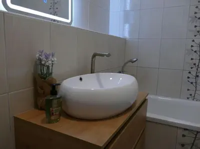 a white sink sitting on a counter in a bathroom at Forest Green Pohorje Apartment in Pohorje