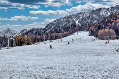 a group of people skiing down a snow covered slope at Country House Viktor in Kranjska Gora