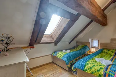 a attic bedroom with two beds and a window at Country House Viktor in Kranjska Gora
