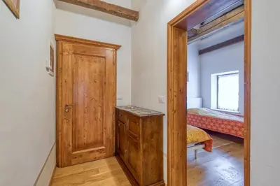 a room with a wooden door and a bedroom at Country House Viktor in Kranjska Gora