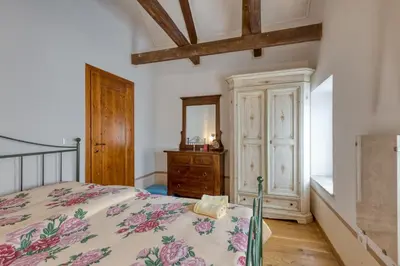 a bedroom with a bed and a dresser and a mirror at Country House Viktor in Kranjska Gora