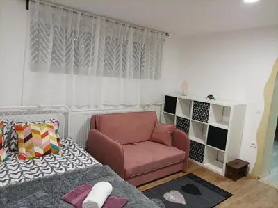 a living room with a chair and a couch at Apartma Juli in Žirovnica