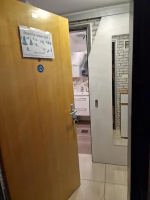 a door leading into a kitchen with a sign on it at Apartma GABER 125 - Rogla in Zreče