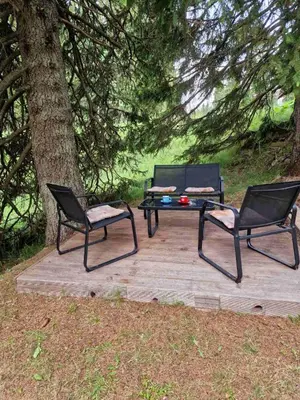 two chairs and a picnic table next to a tree at Apartma GABER 125 - Rogla in Zreče
