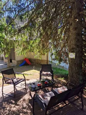 two chairs and a table under a tree at Apartma GABER 125 - Rogla in Zreče