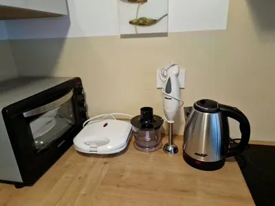 a kitchen counter with a tv and a blender and a coffee maker at Apartma GABER 125 - Rogla in Zreče