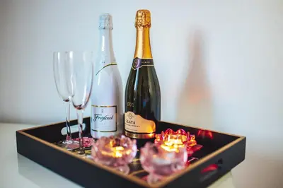 a tray with two bottles of champagne and glasses at Central Living Vegova-with parking in Ljubljana