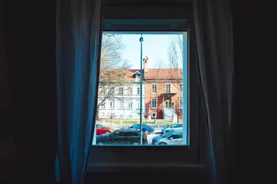 a window with a view of a parking lot at Central Living Vegova-with parking in Ljubljana