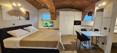 a bedroom with a bed and a desk in a room at AppPrusnik in Ljubljana