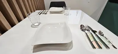 a white table with utensils on top of it at AppPrusnik in Ljubljana