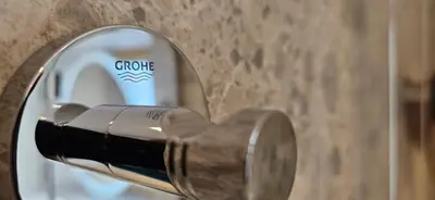 a close up of a door handle with a bottle of champagne at AppPrusnik in Ljubljana