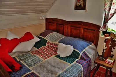 a bedroom with a bed with a quilt on it at Studio in Novo mesto - dostava - Kranjska Krain 26035 in Mačkovec pod Trško Goro