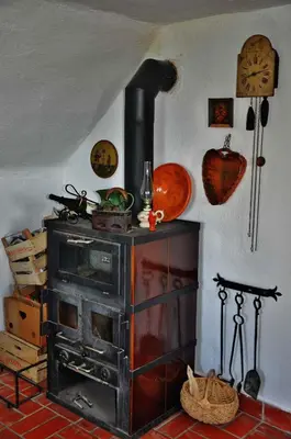 an old stove in the corner of a room at Studio in Novo mesto - dostava - Kranjska Krain 26035 in Mačkovec pod Trško Goro