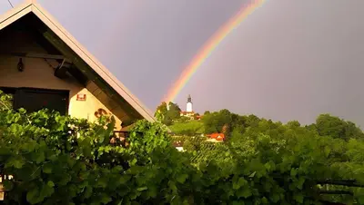 a rainbow in the sky over a house at Studio in Novo mesto - dostava - Kranjska Krain 26035 in Mačkovec pod Trško Goro