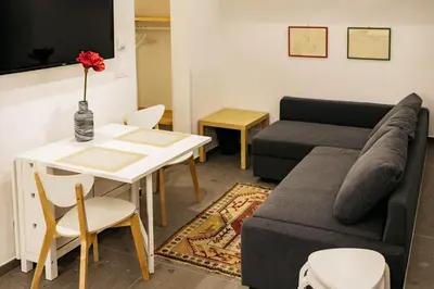 a living room with a couch and a table at Vila Jakopič apartments in Ljubljana