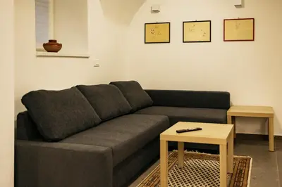 a living room with a couch and a table at Vila Jakopič apartments in Ljubljana