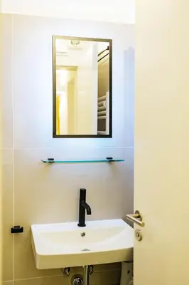 a bathroom with a sink and a mirror at Vila Jakopič apartments in Ljubljana