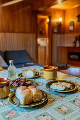 a table with plates of food on top of it at Velika planina - Chalet Stane - Alps in Stahovica