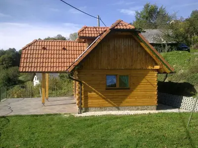 a small wooden house with a red roof at Holiday home in Srednje Grcevje - Kranjska Krain 26064 in Srednje Grčevje