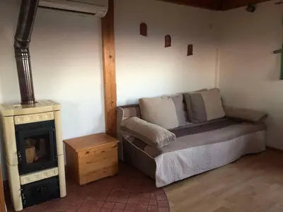a room with a couch and a fireplace and a stove at Holiday home in Srednje Grcevje - Kranjska Krain 26064 in Srednje Grčevje