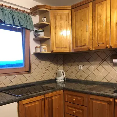 a kitchen with wooden cabinets and a counter top at Holiday home in Srednje Grcevje - Kranjska Krain 26064 in Srednje Grčevje