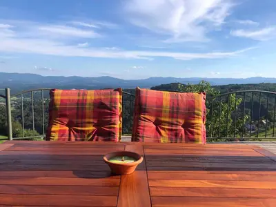 a deck with two chairs and a bowl on a table at Holiday home in Srednje Grcevje - Kranjska Krain 26064 in Srednje Grčevje