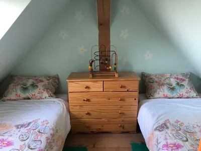 a bedroom with two twin beds and a wooden dresser at Holiday home in Srednje Grcevje - Kranjska Krain 26064 in Srednje Grčevje