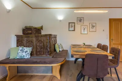 a dining room with a wooden table and chairs at Vilaraj in Maribor