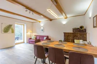 a dining room with a wooden table and chairs at Vilaraj in Maribor