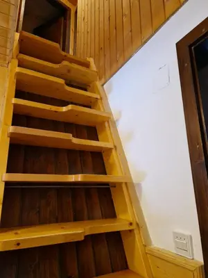 a staircase in a tiny house at Triglav Cottage in Bohinj