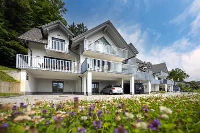 a house with a car parked in front of it at Luxury Apartment Stilla in Bled