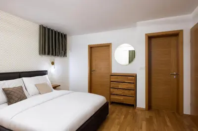 a bedroom with a white bed and a mirror at Luxury Apartment Stilla in Bled