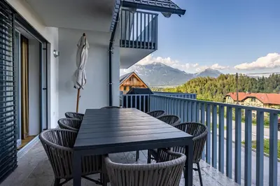 a table and chairs on a balcony with a view at Luxury Apartment Stilla in Bled